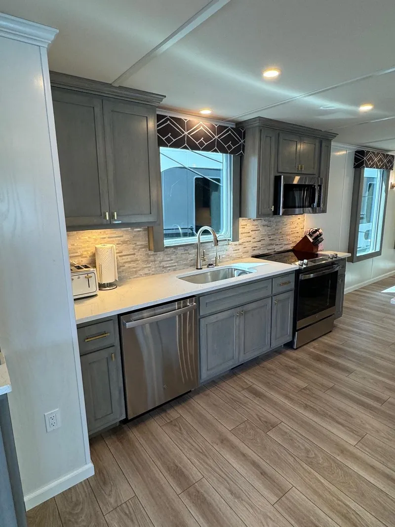 Slide: The Image of Modern kitchen in 2024 Sumerset Limitless Share 10 houseboat with stainless steel appliances. - 5