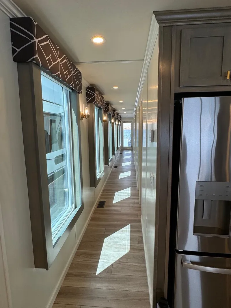 Slide: The Image of 2024 Sumerset Limitless Share 10 interior hallway with large windows and modern design. - 8