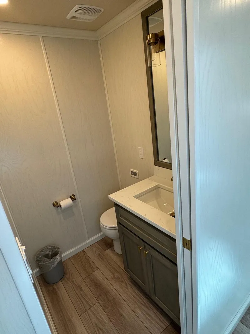 Slide: The Image of 2024 Sumerset Limitless Share 10 bathroom with modern fixtures and wood flooring. - 9