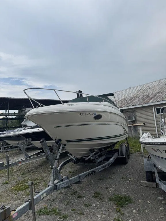 Slide: The Image of 1999 Sea Ray Weekender 240 on trailer, docked outdoors. - 2