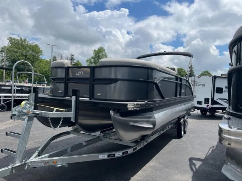 Slide: The Image of 2024 Barletta Cabrio Ultra Lounge C24UC pontoon boat on a trailer under a cloudy sky. - 3