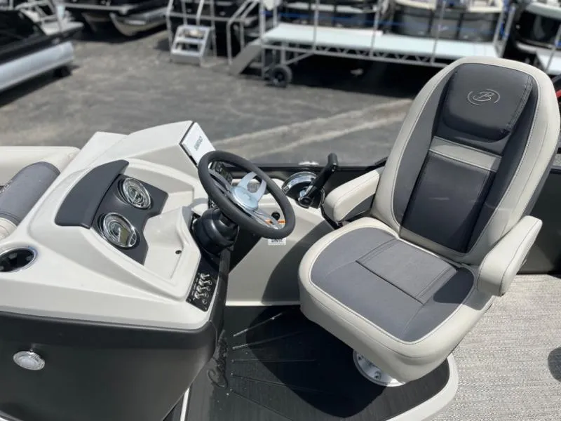 Slide: The Image of 2024 Barletta Cabrio Ultra Lounge C24UC boat helm with captain's chair and steering wheel. - 7