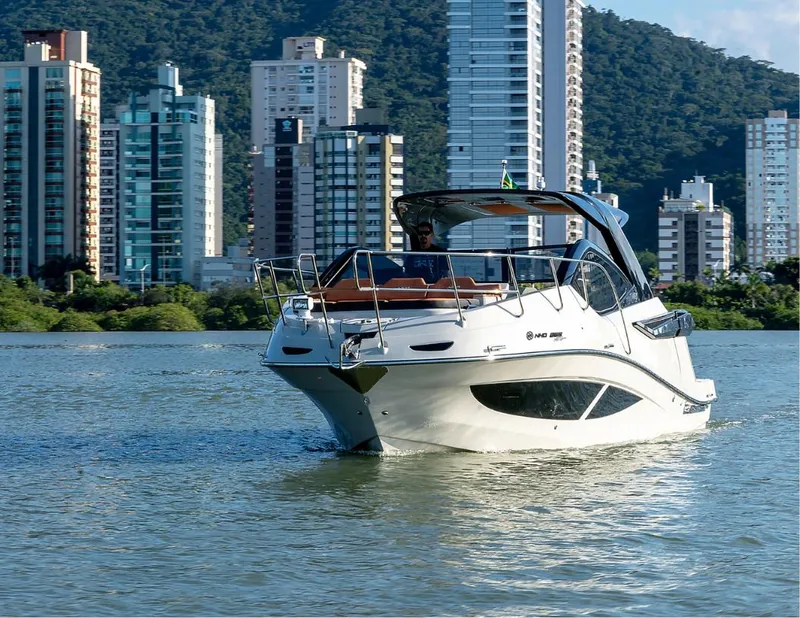 Slide: The Image of Luxury NHD 355 All Space 2025 boat cruising near city skyline. - 2