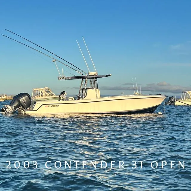 Slide: The Image of 2003 Contender 31 Open fishing boat on calm waters under clear blue sky. - 0