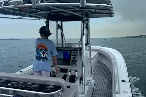 Slide: The Image of Person steering a 2003 Contender 31 Open boat on a calm sea. - 10