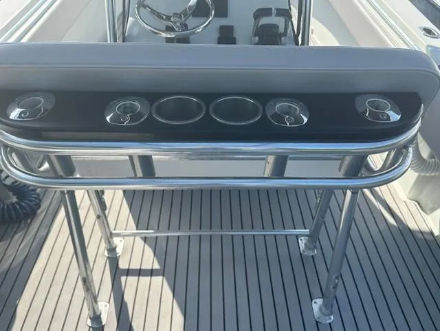 Slide: The Image of 2003 Contender 31 Open boat console with rod holders and cup holders. - 15