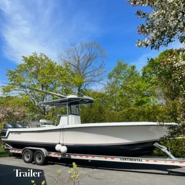 Slide: The Image of 2003 Contender 31 Open boat on Continental trailer, surrounded by trees. - 16