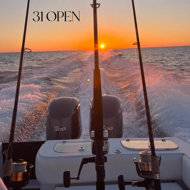 Slide: The Image of Contender 31 Open 2003 boat at sunset with fishing rods and twin engines. - 18