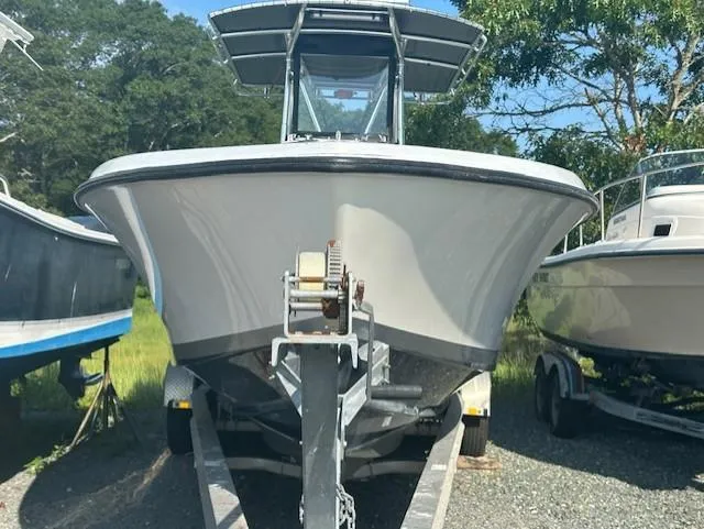 Slide: The Image of 2003 Contender 31 Open boat on trailer, front view, parked outdoors. - 19
