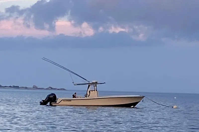 Slide: The Image of 2003 Contender 31 Open boat anchored on calm water at sunset. - 2