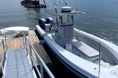 Slide: The Image of 2003 Contender 31 Open boat docked at a wooden pier. - 3