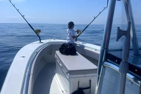 Slide: The Image of Person fishing on a 2003 Contender 31 Open boat in open water. - 6