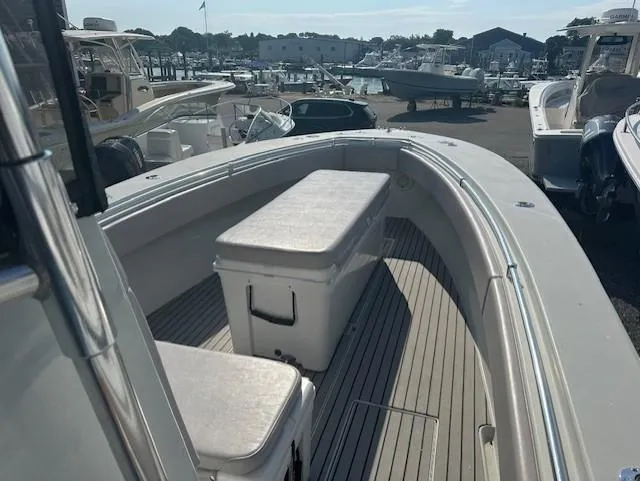 Slide: The Image of 2003 Contender 31 Open boat with spacious deck and seating at a marina. - 7