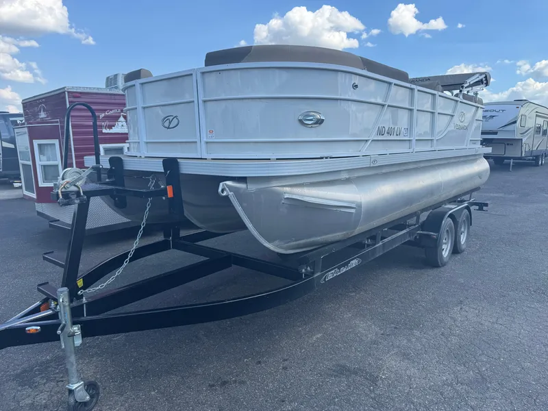 Slide: The Image of 2023 Veranda Relax VR20RC pontoon boat on trailer under a blue sky. - 1
