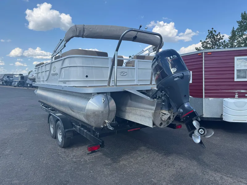 Slide: The Image of 2023 Veranda Relax VR20RC pontoon boat on trailer, featuring Yamaha outboard motor. - 4