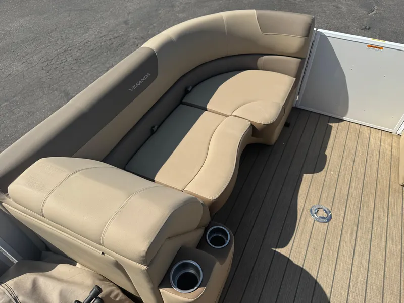 Slide: The Image of 2023 Veranda Relax VR20RC boat interior with beige seating and cup holders. - 6