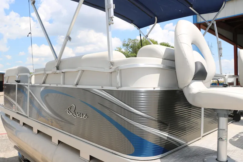 Slide: The Image of 2020 Qwest 818 EDGE pontoon boat with blue and silver accents under a blue canopy. - 9