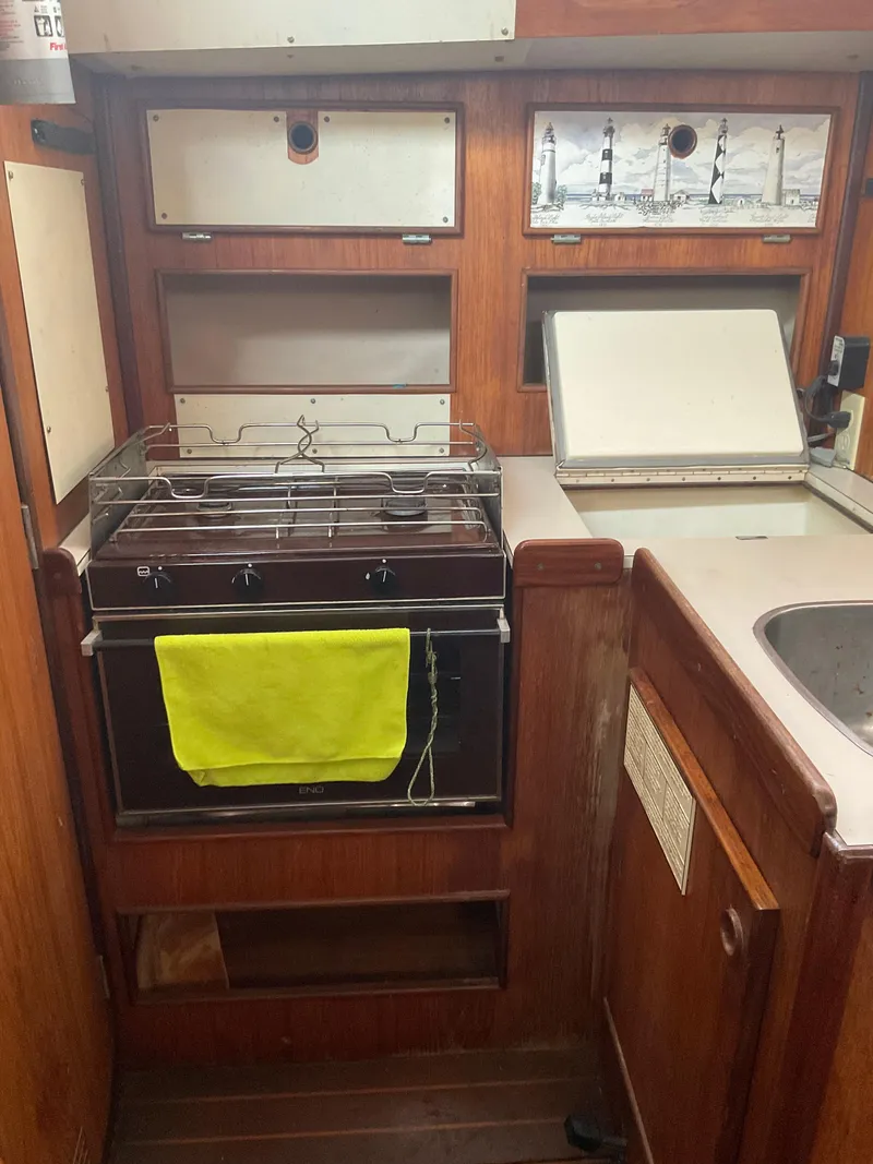 Slide: The Image of Interior of 1983 Jeanneau Attalia sailboat kitchen with stove and sink. - 10