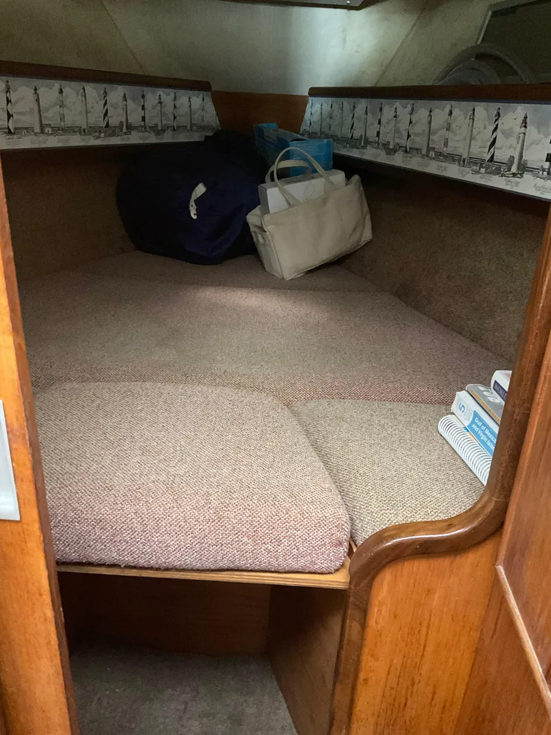 Slide: The Image of Cozy cabin interior of 1983 Jeanneau Attalia sailboat with cushions and storage bags. - 16