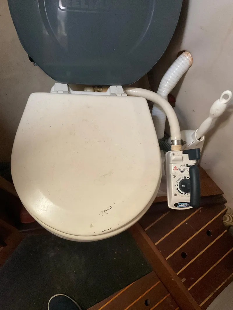 Slide: The Image of Marine toilet on a 1983 Jeanneau Attalia sailboat, featuring manual pump controls. - 2