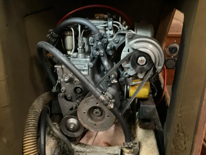 Slide: The Image of Engine compartment of a 1983 Jeanneau Attalia sailboat, showcasing mechanical components. - 24