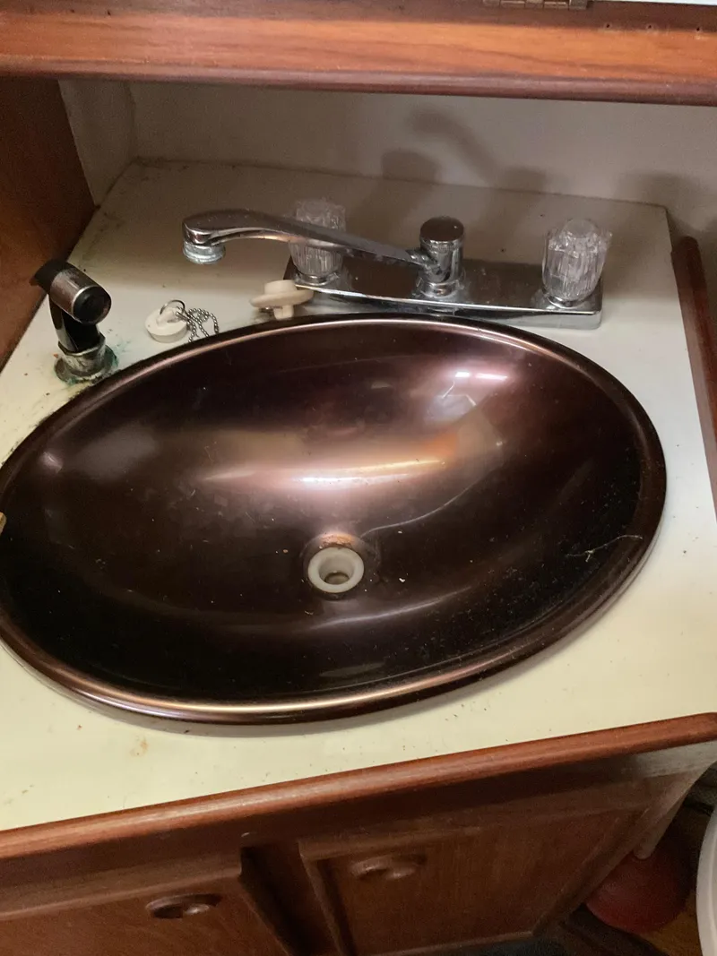 Slide: The Image of Brown sink in a 1983 Jeanneau Attalia yacht bathroom with wooden cabinetry. - 3