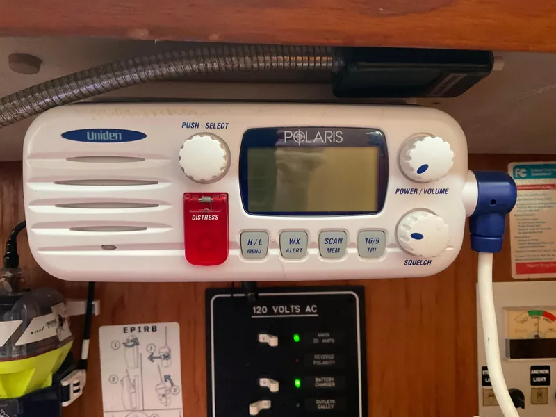 Slide: The Image of Uniden Polaris marine radio on 1983 Jeanneau Attalia sailboat, featuring distress button and control knobs. - 7