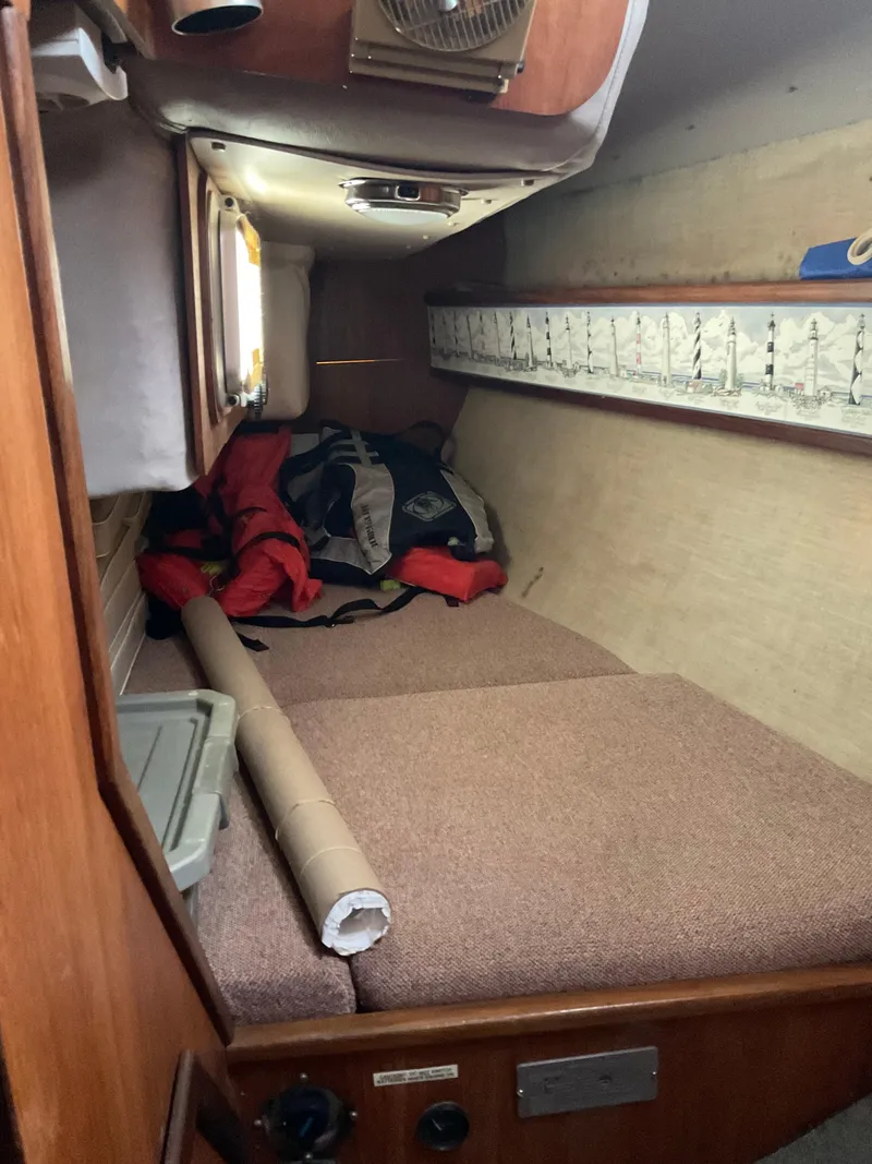 Slide: The Image of Interior cabin of 1983 Jeanneau Attalia sailboat with cozy bedding and storage. - 8