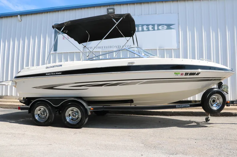 Slide: The Image of 2008 Glastron GT225 boat on a trailer with black canopy. - 1