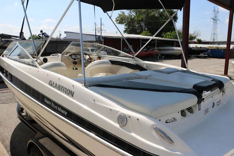 Slide: The Image of 2008 Glastron GT225 boat in marina, white exterior, open cockpit, North Texas Marine. - 10