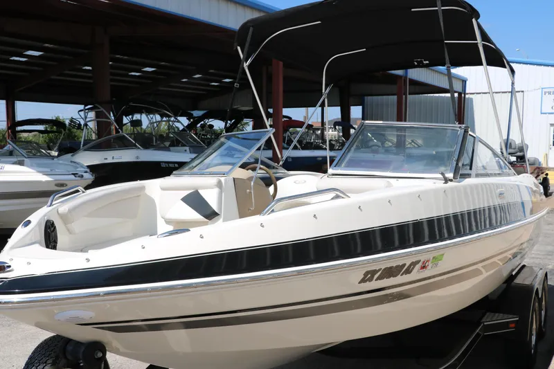 Slide: The Image of 2008 Glastron GT225 boat with black bimini top in marina. - 12