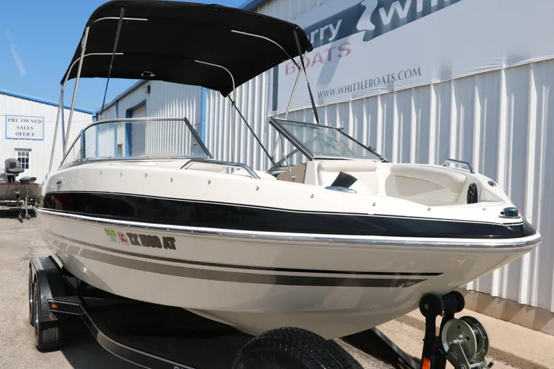 Slide: The Image of 2008 Glastron GT225 boat with black canopy on trailer. - 14