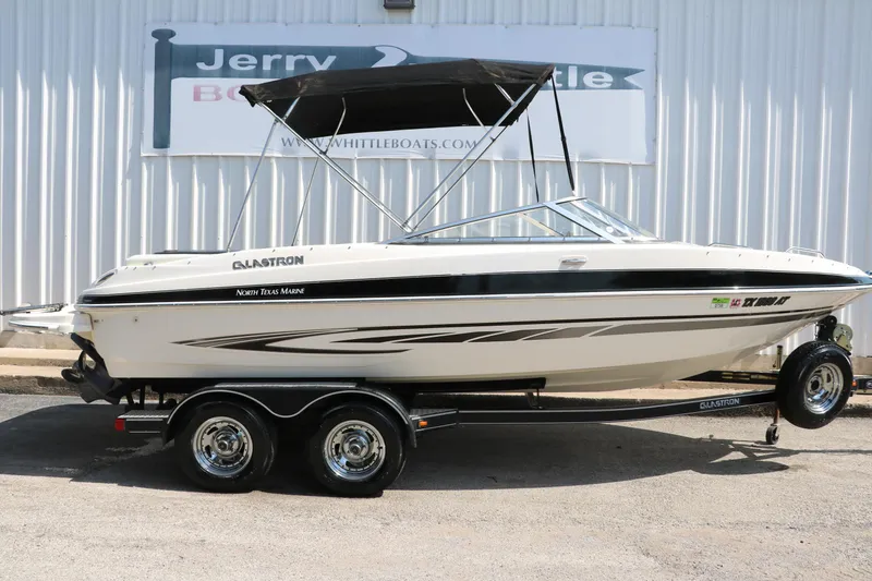 Slide: The Image of 2008 Glastron GT225 boat on trailer with black canopy. - 18
