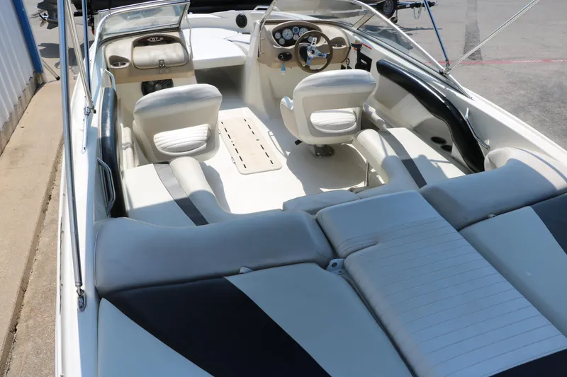 Slide: The Image of 2008 Glastron GT225 boat interior with white and black seating. - 19