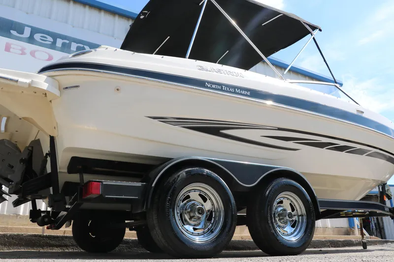 Slide: The Image of 2008 Glastron GT225 boat on trailer with North Texas Marine branding. - 2