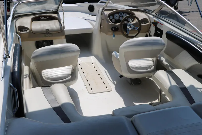 Slide: The Image of 2008 Glastron GT225 boat interior with white seating and dashboard. - 20