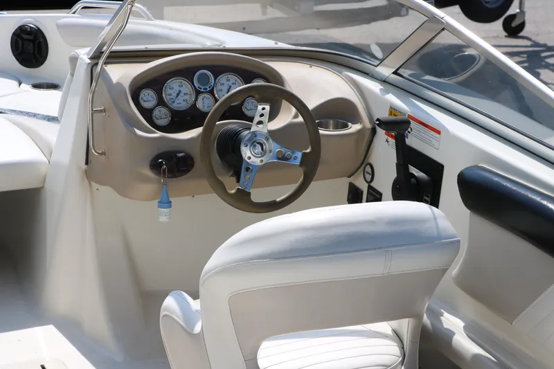Slide: The Image of 2008 Glastron GT225 boat interior with steering wheel and dashboard. - 21