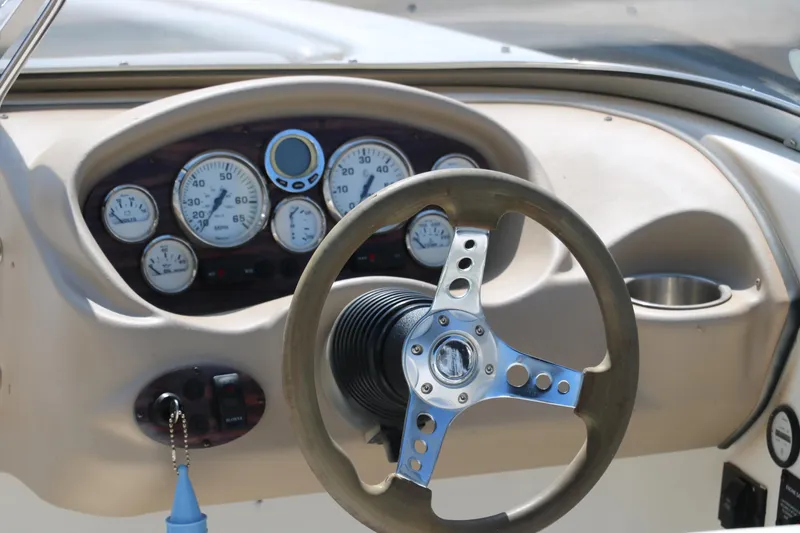 Slide: The Image of 2008 Glastron GT225 boat dashboard with steering wheel and gauges. - 22