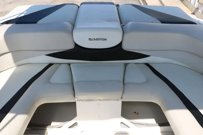 Slide: The Image of 2008 Glastron GT225 boat interior seating with white and black upholstery. - 26