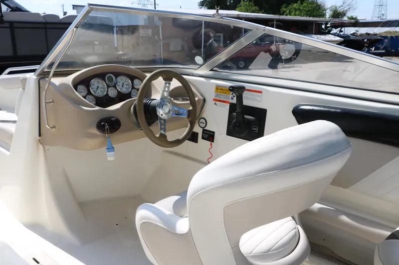 Slide: The Image of 2008 Glastron GT225 boat cockpit with steering wheel and dashboard. - 29