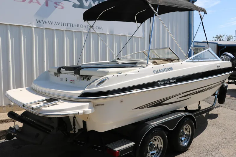Slide: The Image of 2008 Glastron GT225 boat on a trailer with a black canopy. - 3