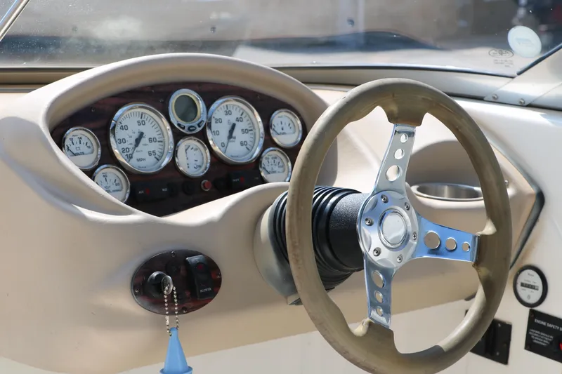 Slide: The Image of 2008 Glastron GT225 boat dashboard with steering wheel and gauges. - 30