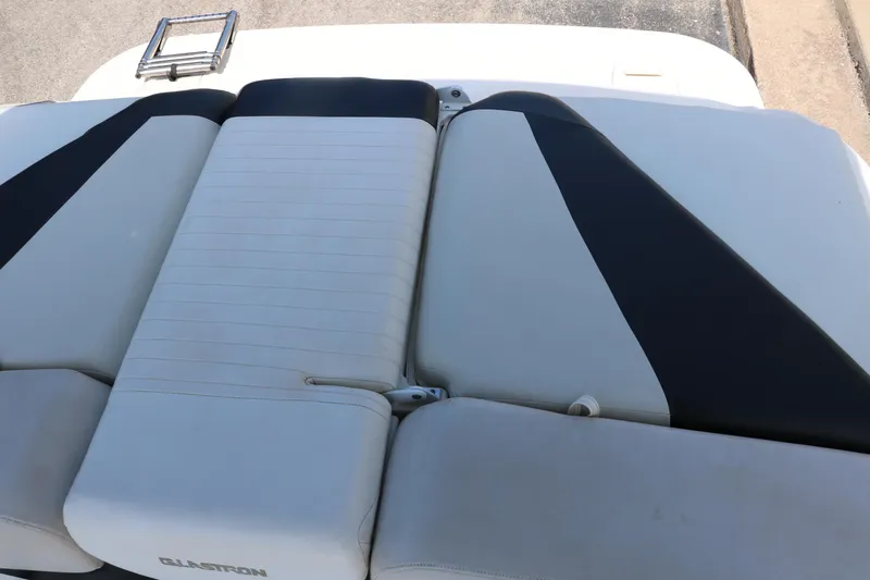 Slide: The Image of 2008 Glastron GT225 boat rear seating area with white and black upholstery. - 33