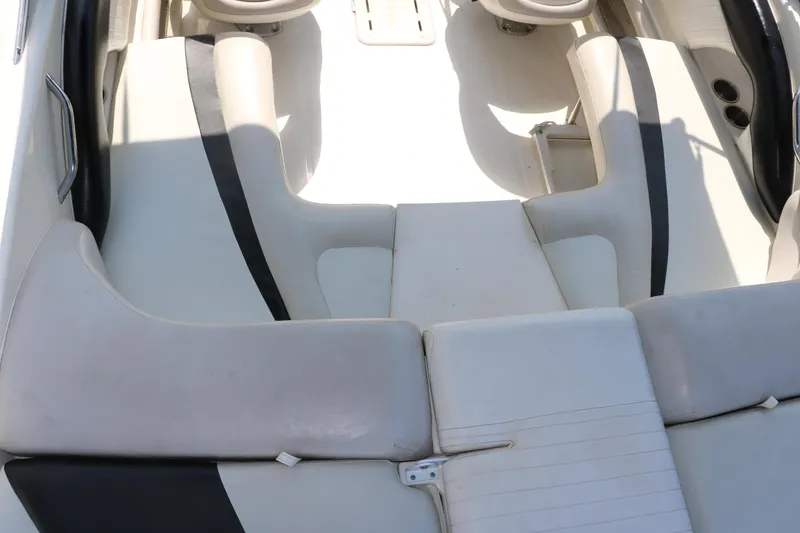 Slide: The Image of 2008 Glastron GT225 boat interior with white and black seating. - 35