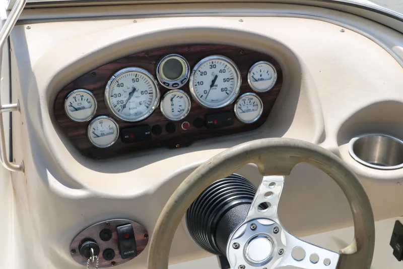 Slide: The Image of 2008 Glastron GT225 boat dashboard with gauges and steering wheel. - 36