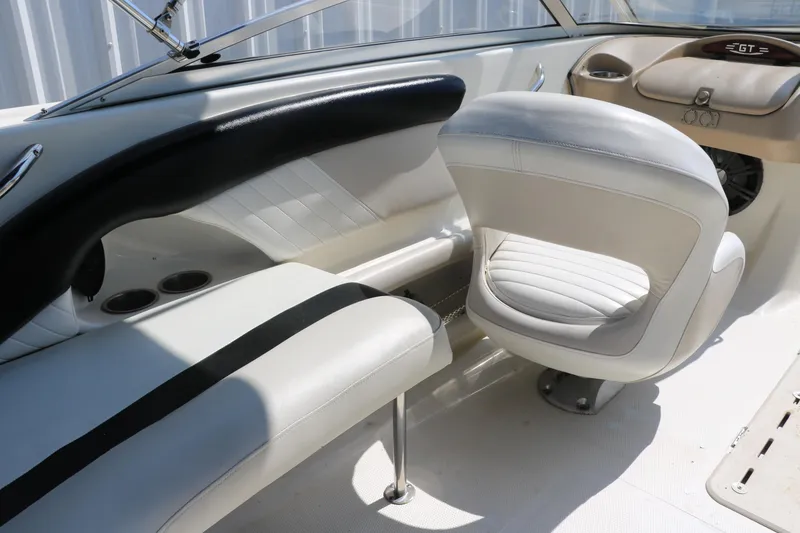 Slide: The Image of Interior of a 2008 Glastron GT225 boat with white and black seating. - 40