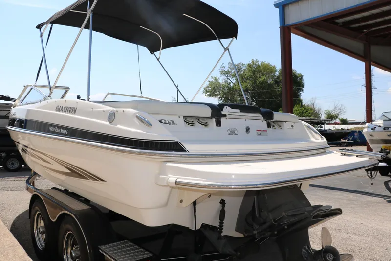 Slide: The Image of 2008 Glastron GT225 boat on a trailer with a black canopy. - 7