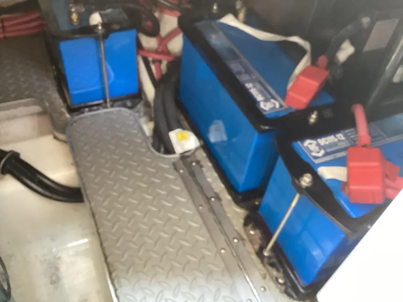 Slide: The Image of 2007 Formula 400 Super Sport boat battery compartment with blue batteries and red cables. - 17