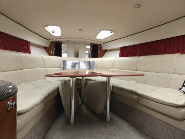 Slide: The Image of Interior of 2007 Formula 400 Super Sport yacht with beige seating and wooden table. - 19