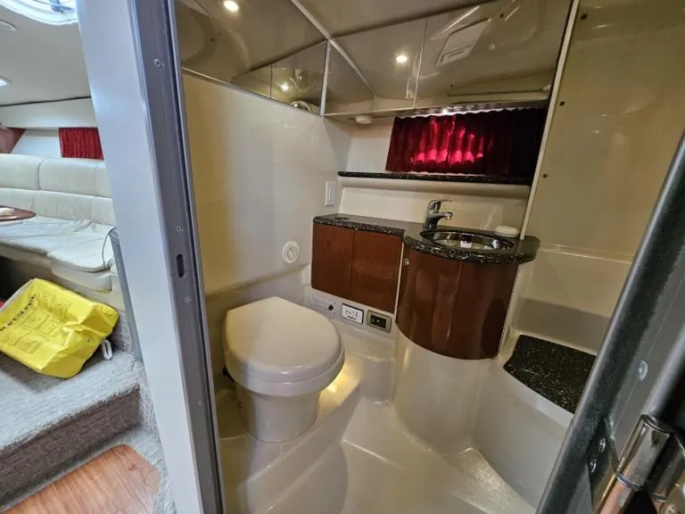 Slide: The Image of 2007 Formula 400 Super Sport yacht bathroom with sink, toilet, and cabin view. - 20